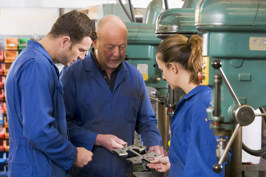 a woman and two men at work