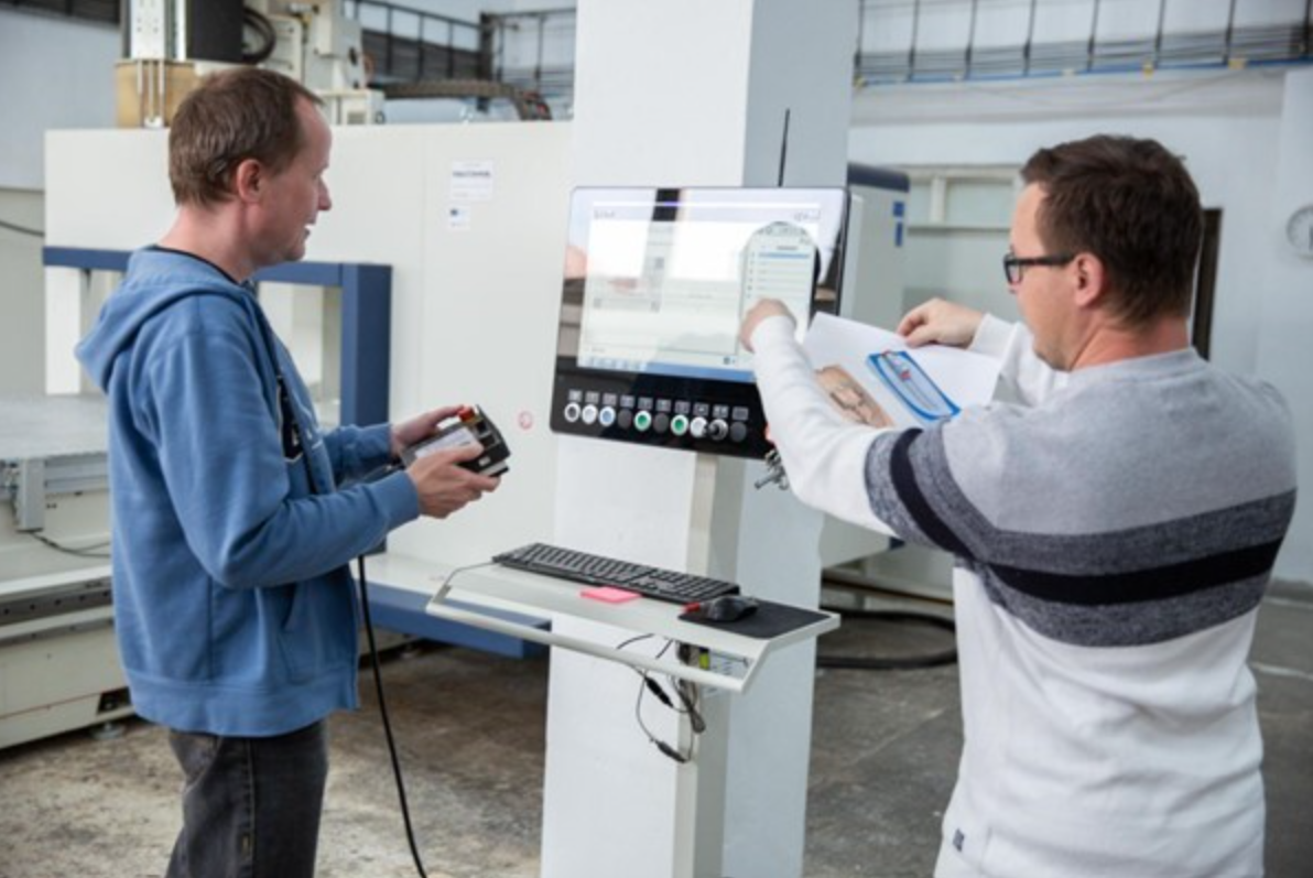 Pavol Bezák and Radoslav Lovecký working on CNC machine for the prototype part. 