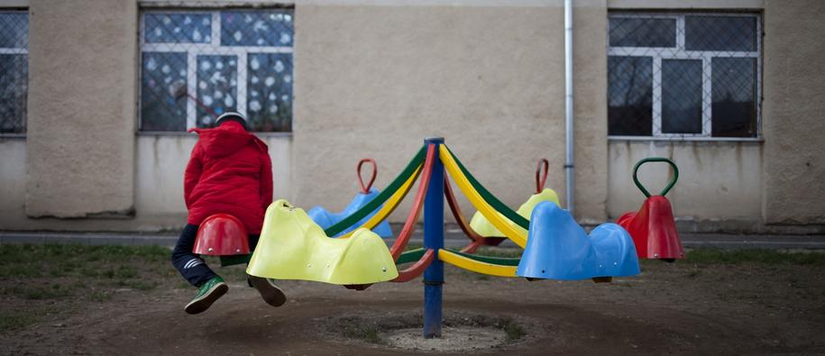 Child playing in a run-down playground