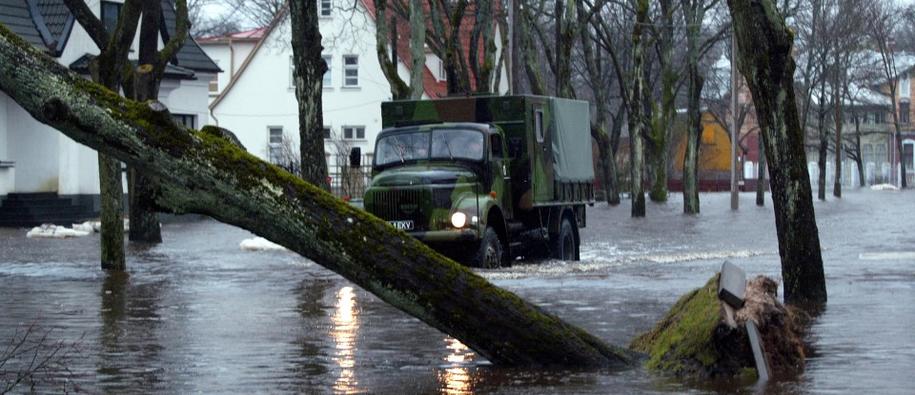 A truck drives through a flooded street