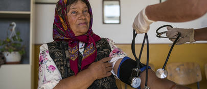 An elderly woman getting her blood pressure measured 